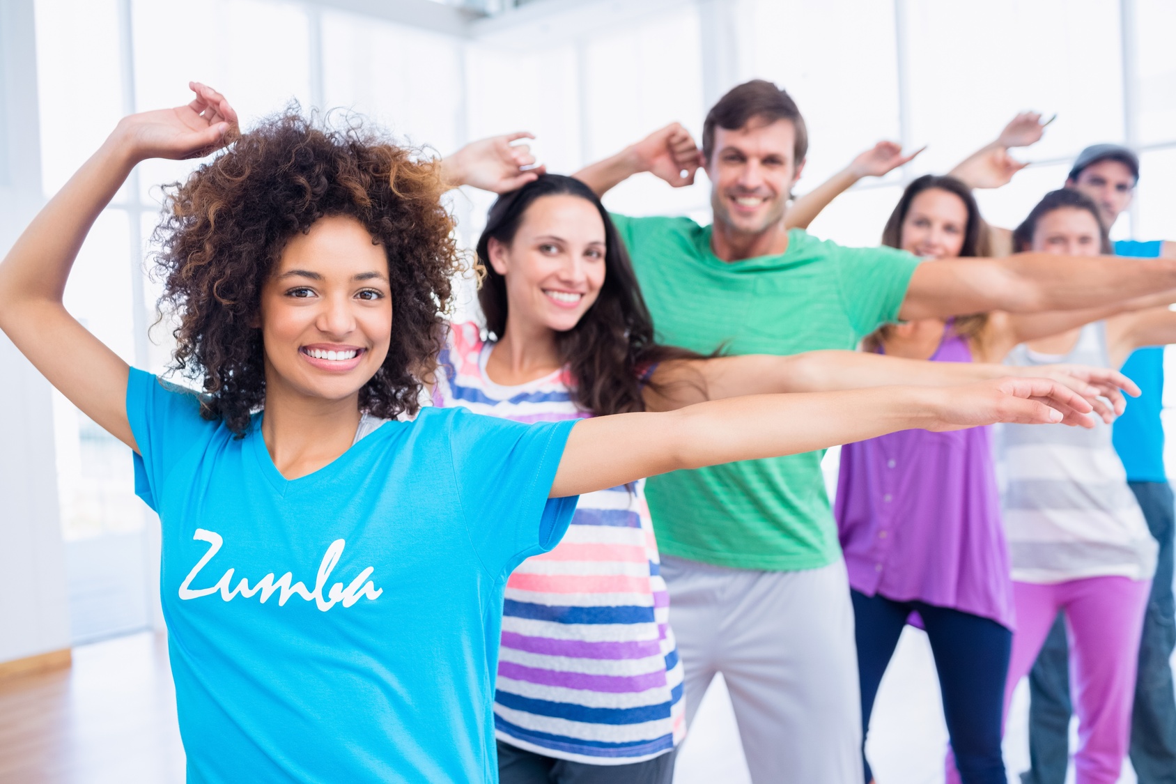 Fitness class and instructor doing pilates exercise